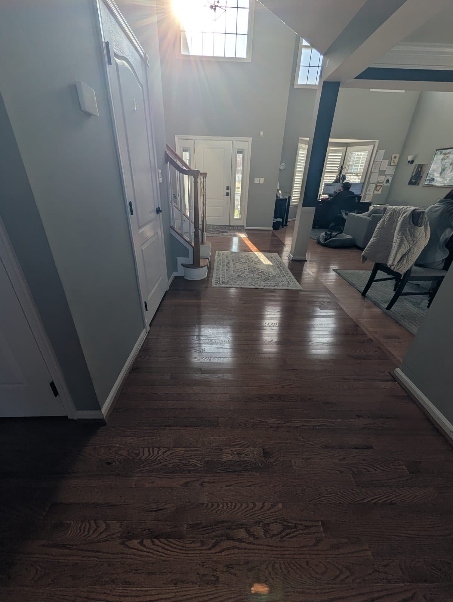 Refinished hardwood flooring in an entry hallway