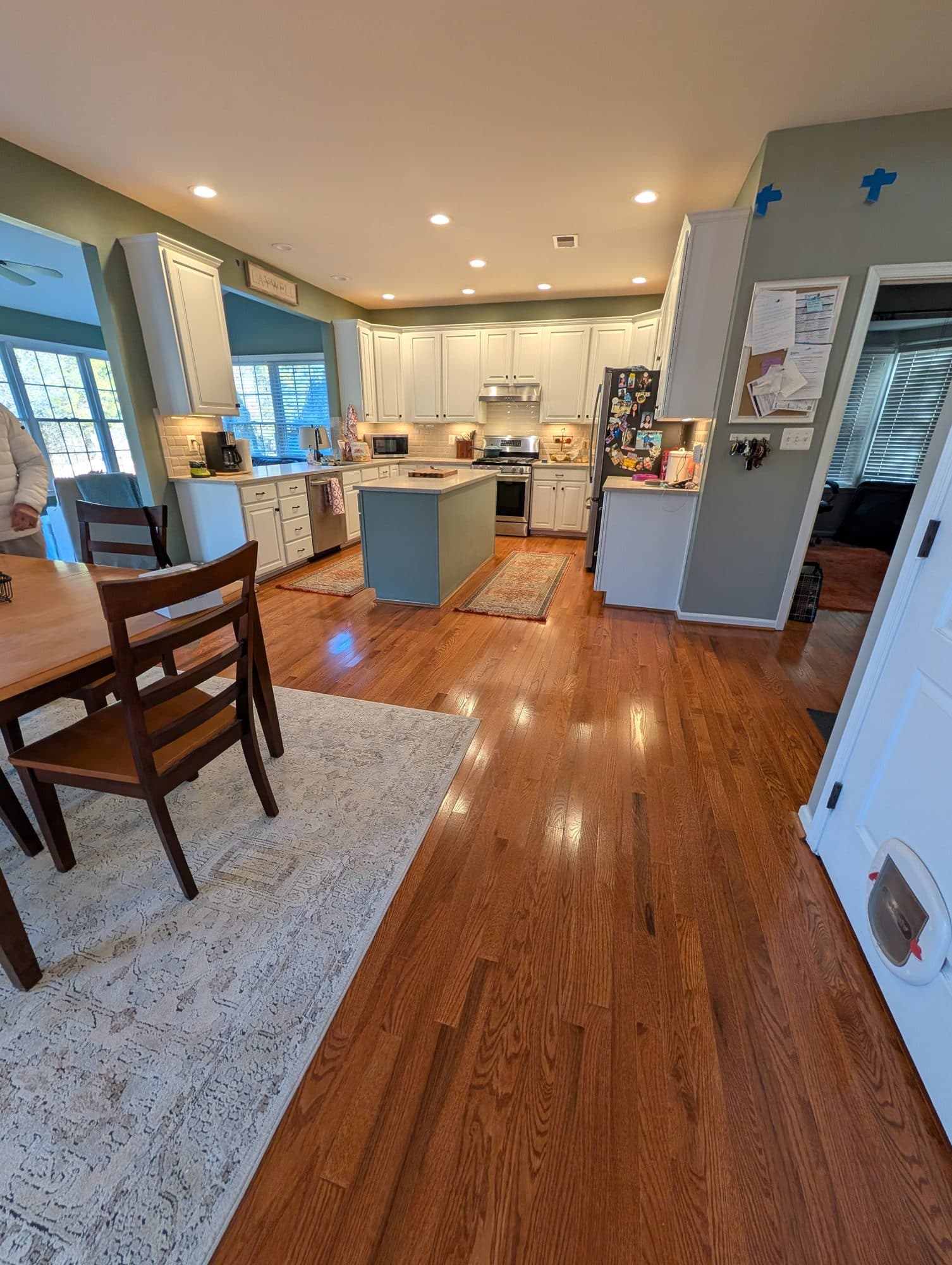Refinished hardwood flooring in a kitchen and dining area