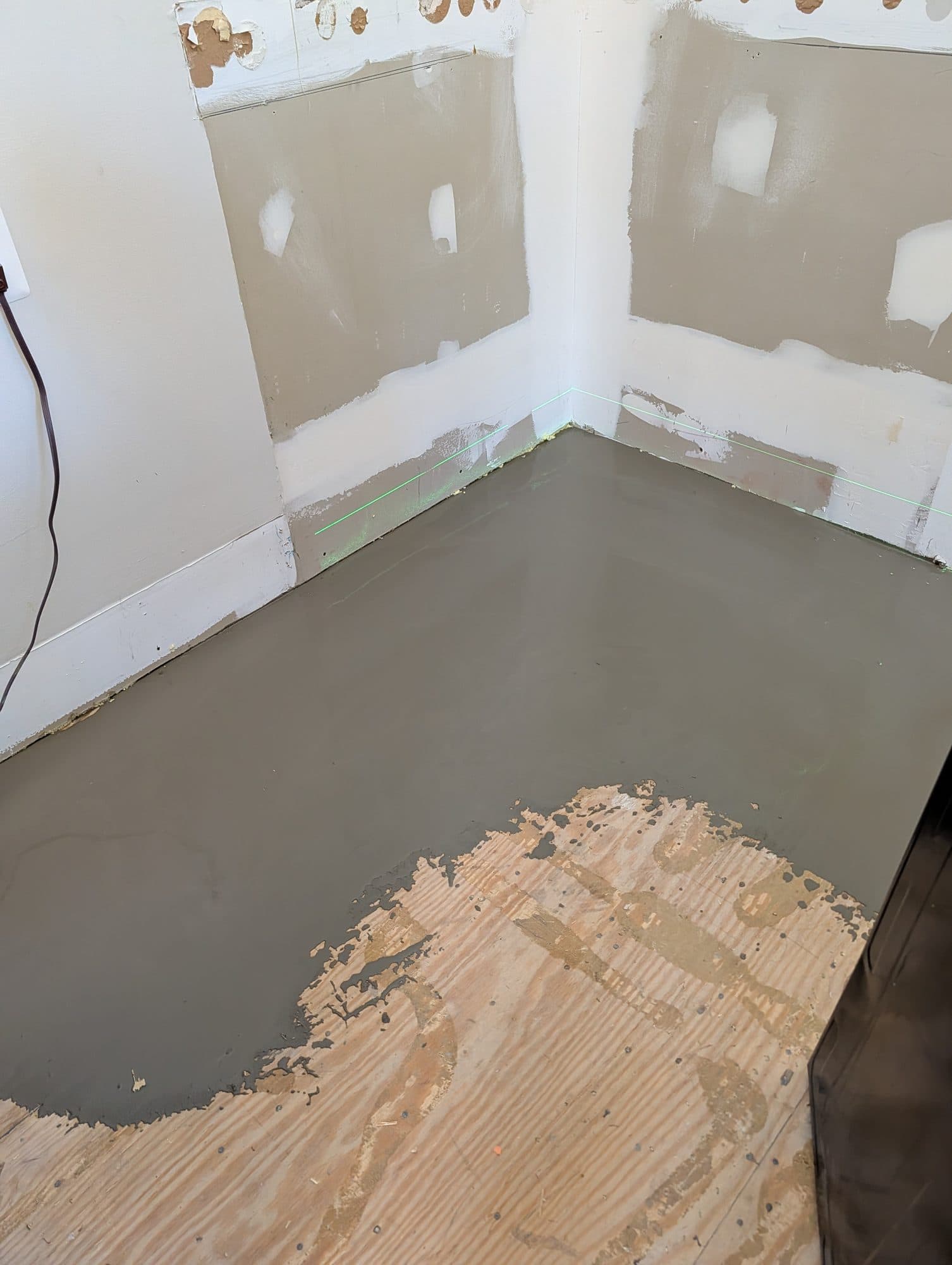 Self-leveling underlayment poured over a subfloor before vinyl plank installation